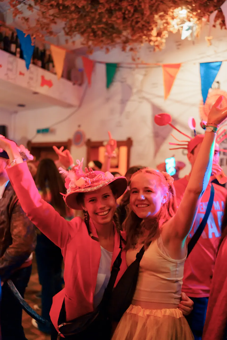 Two friends in costumes cheering with their arms up on 11.11