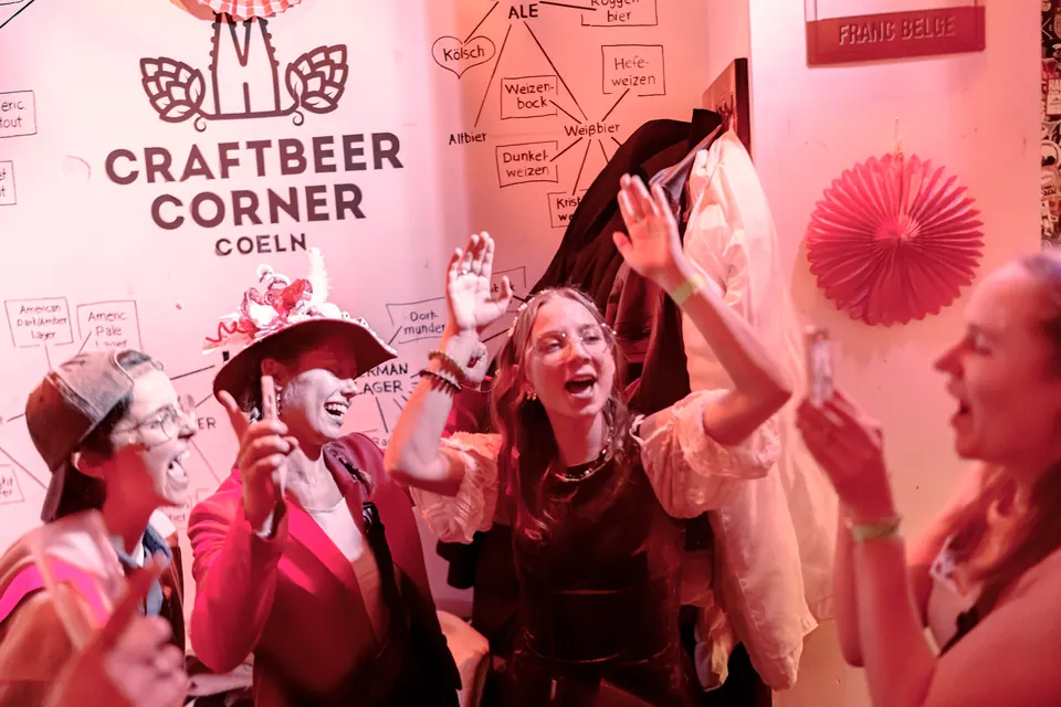Guests in costumes dancing at the Craftbeer Corner wall
