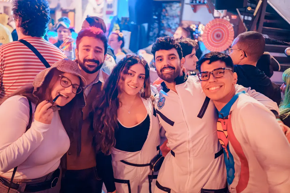 Friends in carnival costumes smiling for the camera at Craftbeer Corner