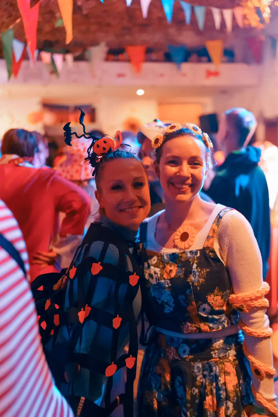 Two friends in carnival costumes smiling together on 11.11