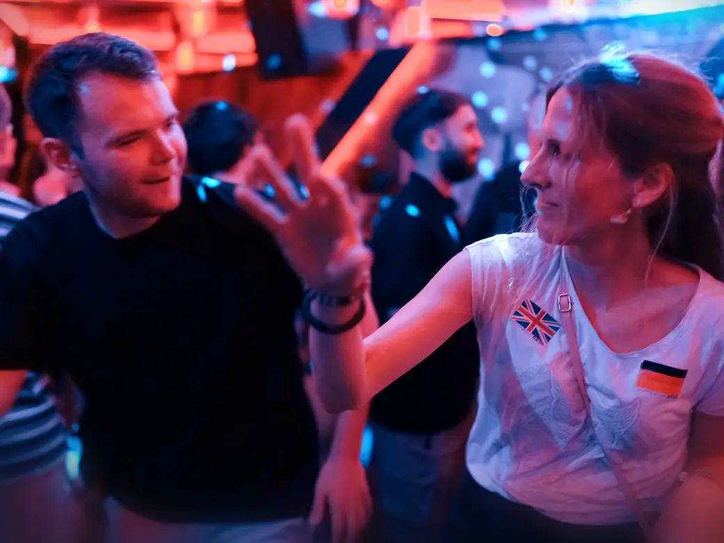 Two new friends dancing and laughing on the dance floor once the party starts at Goldfinger in Cologne