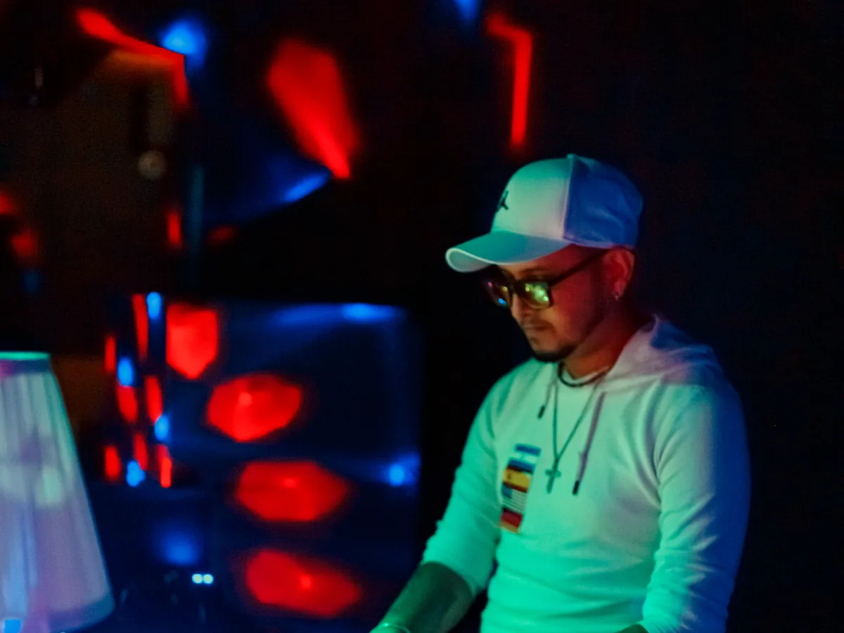 DJ playing a set under red lights at a party night in Hamburg