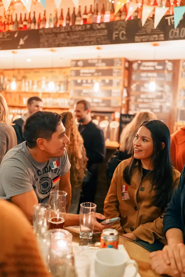 Guests laughing together at a Social Melting Pot event